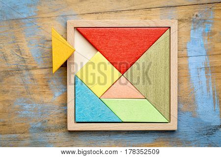 Tangram, a traditional Chinese Puzzle Game made of different wood parts to build abstract figures from them