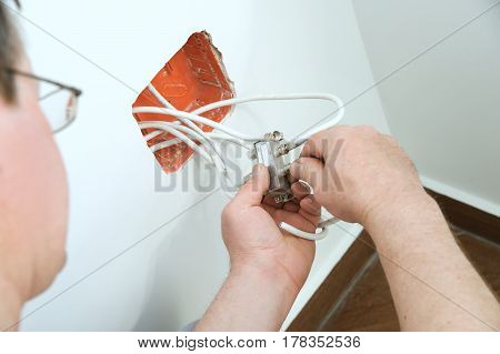 Man inserts a TV antenna cable to a splitter.
