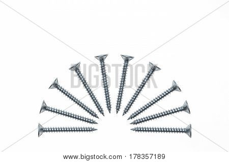 isolated steel screws in semi-circle on white background