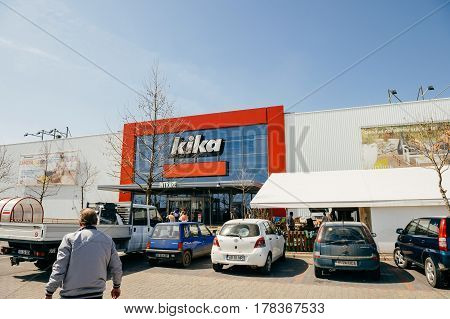 BUCHAREST, ROMANIA - APR 1, 2016: Man walking toward Kika entrance facade of the furniture and household store. Kika is an international chain of furniture stores, headquartered in Austria.