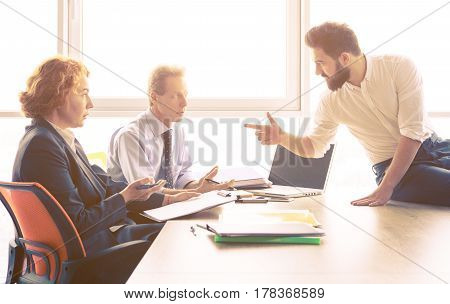 Toned of man explaining employees about his previous companies he worked in. Handsome man offering his CV for investigation of his experience.