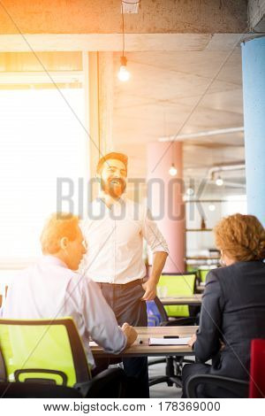 Toned of happy smiling businessman telling about himself to employees. Happy man knows secret how to get positive assessment after interview in company.