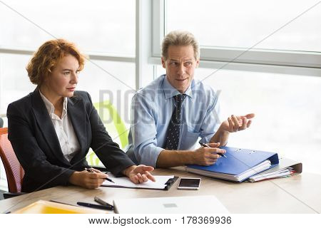 Difficult job interview in board room in office. Business representatives of company asking difficult questions while having interview.