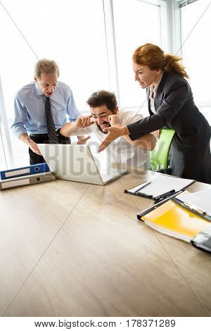 Mobbing, stress, work, scandal concepts. Angry bosses man and woman screaming at their executive worker, because they are not satisfied with his work.