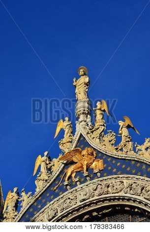 Saint Mark Basilica top statues shines like gold at sunset in Venice (with copy space)