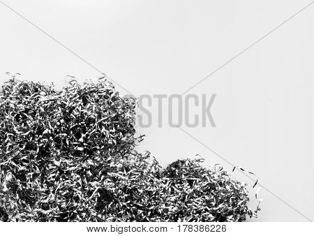 Abstract modern background of a heap of metal shavings and scraps. Twisted steel wire close-up. Texture of silver curly swarfs