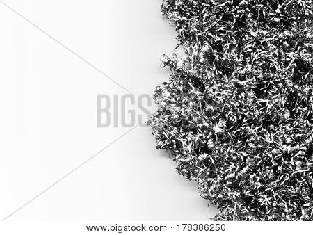 Abstract modern background of a heap of metal shavings and scraps. Twisted steel wire close-up. Texture of silver curly swarfs