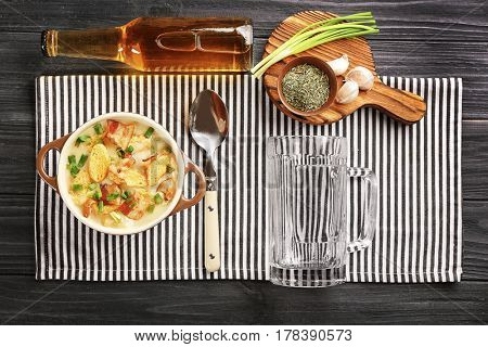 Delicious beer cheese soup with croutons and spices on table, top view