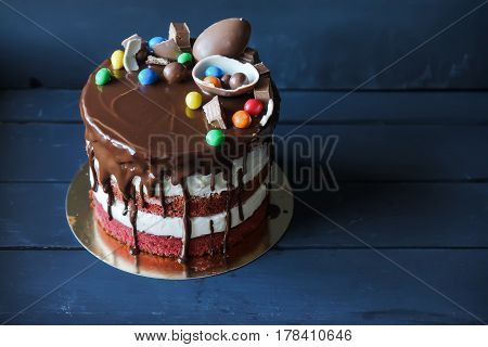Delicious chocolate cake with dark chocolate sauce and with chocolate candies