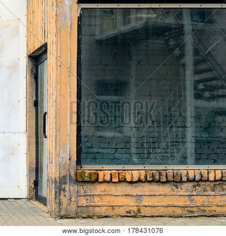 Abandoned storefront. Empty old showcase. Building entry