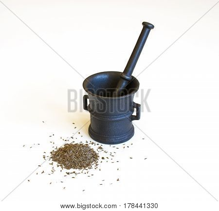 Still life with mortar and cumin seeds isolated on white background