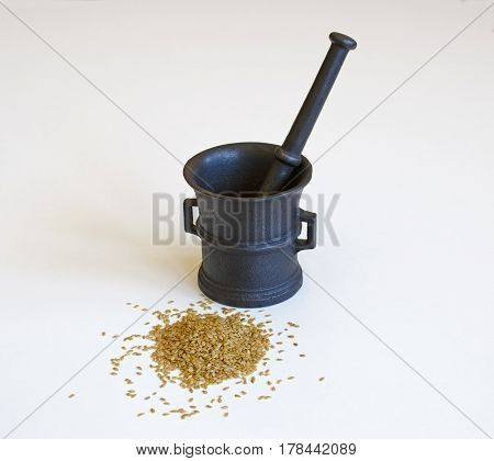 Still life with mortar and golden flax seeds isolated on a white background