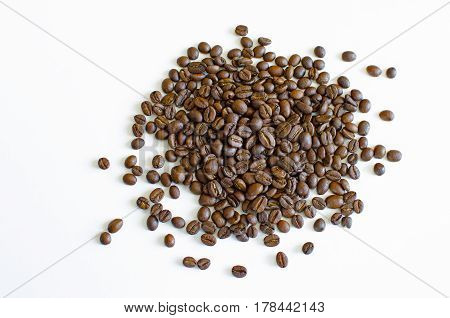 Still Life with spill grains of roasted coffee isolated on white background