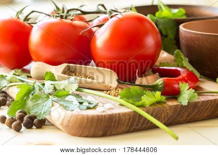 Ingredients for cooking sauce. Sprig of tomatoes parsley garlic mushrooms pepper pots mustard seeds.