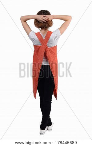 Young redhaired woman chef, waiter or bartender posing, wearing apron and t-shirt isolated on white background. Bartender's clothes.