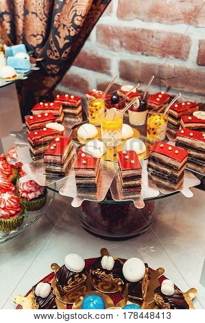 different pastries on the wedding candybar. Table served for wedding party