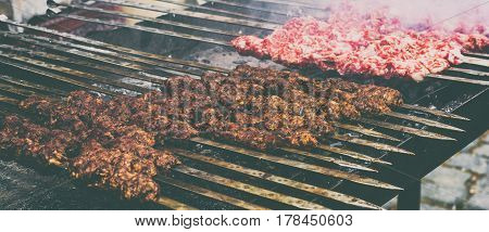 Marinated kebab preparing over charcoal. Selective focus