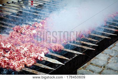 Marinated kebab preparing over charcoal. Selective focus