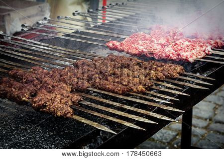 Marinated kebab preparing over charcoal. Selective focus