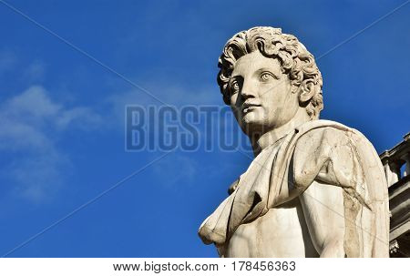 Detail of Dioskouri ancient roman marble statue from the Capitol Hill Square balustrade with blue sky