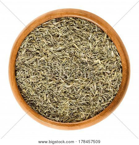Dried thyme in wooden bowl. Minced stems. Herb with culinary and medicinal uses. Thymus vulgaris is a relative of oregano. Isolated macro food photo close up from above on white background.