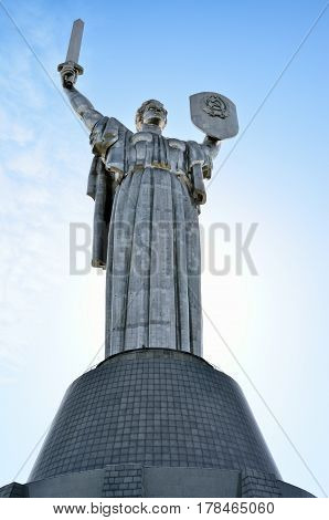 Monument Rodina Mother on the background of the blue sky. Communist symbol of the totalitarian Soviet regime in Kiev Ukraine.