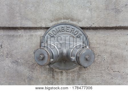 steel fire hydrant in the concrete wall