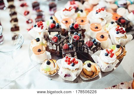 Chocolate pastries on the wedding candybar. Table served for wedding party
