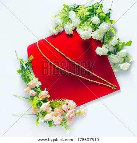 Gold Necklace 96.5 Percent Thai Gold Grade With Flowers Putting On On Red Flannel Cloth Background I