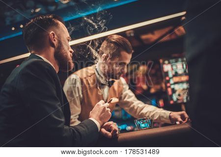 Upper class friends gambling in a casino