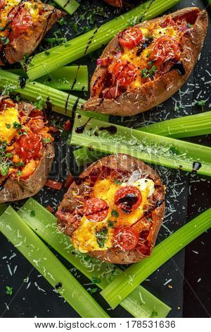 hot baked sweet potato stuffed with bacon, cheddar cheese, cherry tomatoes, balsamic vinegar, cress salad and parmesan sprinkle. Tacco, burrito style