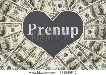 Money and marriage message One hundred dollar bill in the shape of a heart with a chalkboard heart with text Prenup