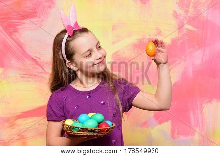 Small Happy Baby Girl Holding Pottle With Easter Eggs