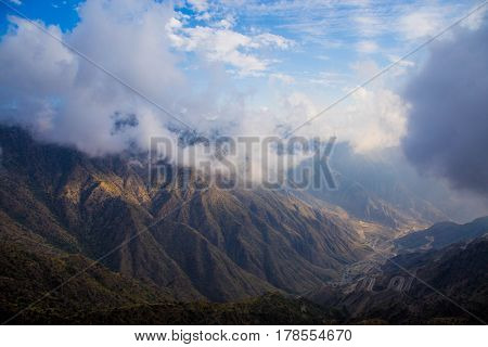 The Sun behind the clouds over mountains