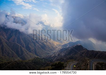 The Sun behind the clouds over mountains
