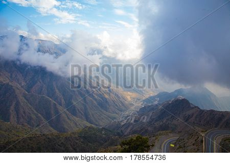The Sun behind the clouds over mountains