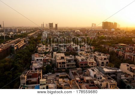 Noida cityscape at dusk with the under construction buildings and golden sunset light