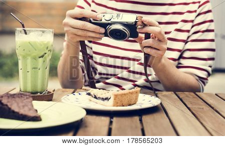 Woman holiday lifestyle taking photo cake dessert