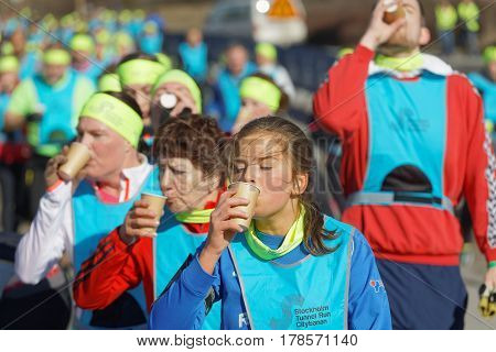 STOCKHOLM SWEDEN - MAR 25 2017: Group of runners drinking water in the Stockholm Tunnel Run Citybanan 2017. March 25 2017 in Stockholm Sweden