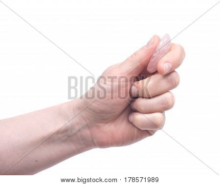 Young woman's hand holding rose quartz worry stone isolated on white background