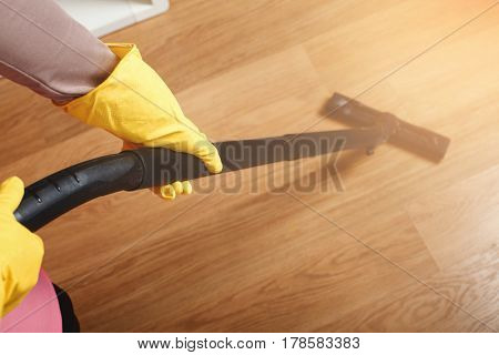 Female hands in rubber gloves hlods brush cleaner