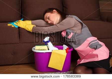 Female cleaning servisce worker asleep on a couch