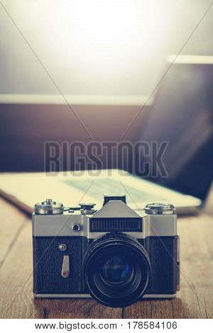 Retro camera on wood table background. Vintage camera. Film cameras that had been popular in the past. Vintage tone.