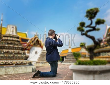 Male camerist taking picture of the temple