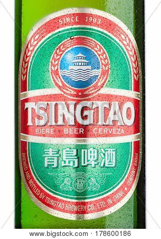 LONDONUK - MARCH 23 2017 : Bottle label of Tsingtao beer on white background.Tsingtao is China's second largest brewery it was founded in 1903 by German settlers.