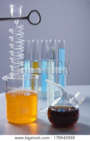 Multicolored liquids in laboratory glassware on a gray background
