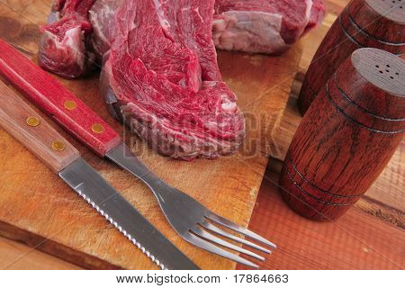 savory: uncooked raw bloody beef meat steak before cooking on wood