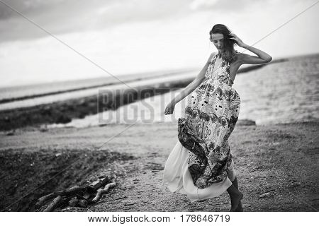 Lonely sad woman on the beach, Black and white photo
