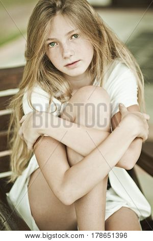Girl teenager sitting in a chair sensual