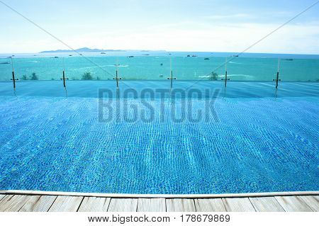 relax at swimming pool with blue sky and island view